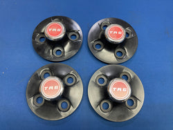 TR6 BLACK HUB CAP SET WITH BADGES BINP26/27